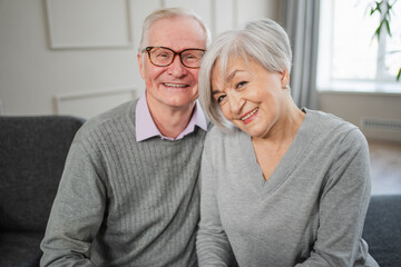 Senior adult mature couple hugging at home. Mid age old husband and wife embracing with tenderness love enjoying sweet bonding wellbeing. Grandmother grandfather together. Family moment love and care