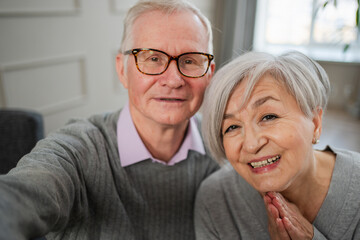 Happy senior woman man talk on video call with friends family. Mature old grandmother grandfather talking speaking with grown up children online. Older generation modern tech usage. Webcamera view