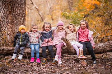 Group Of Young Children having fun on Autumn Forest