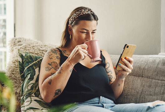 Home, coffee and woman on sofa, smartphone and internet with social media, texting and connection. Communication, person and girl on couch, cellphone and typing with message to contact or morning tea