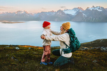 Child playing with mother family hike in mountains outdoor activity, travel together in Norway...