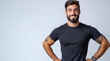 Young sport handsome man with beard over isolated white background posing with arms at hip and smiling. 