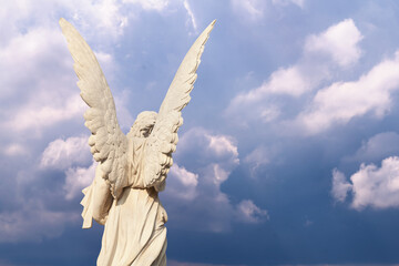 Back view of angel as symbol of death and end of human life. Copy space.