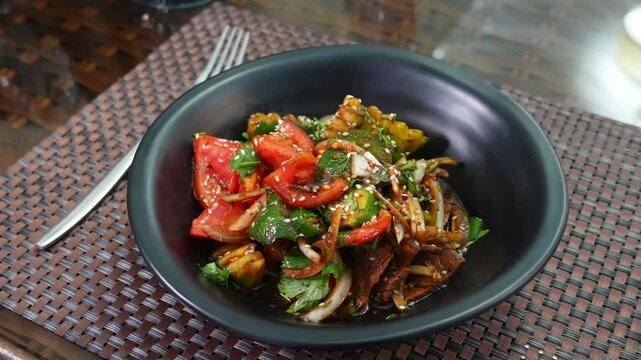 salad of ofaschi, pepper, greens. Garnished with sesame seeds and sauce