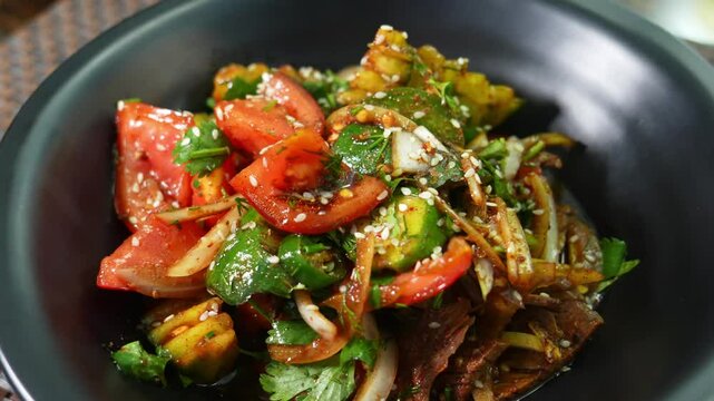 salad of ofaschi, pepper, greens. Garnished with sesame seeds and sauce