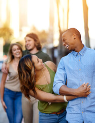 City, walking and couple of friends for journey, travel vacation and bonding together for reunion. Happy people, men and women with hug for relationship, double date and group by sunshine in downtown