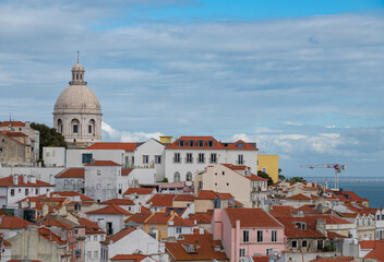 View of the cityscape of Lisbon, Portugal, with Sao Jorge Castle and the red roofes of the Alfama district