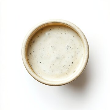 Top view of a paper cup with ranch dressing isolated on white background