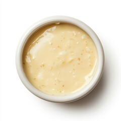 Top view of a porcelain ramekin with béchamel sauce isolated on white background