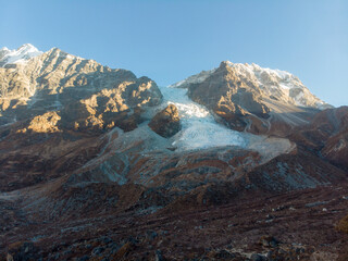 A stunning view of snow-capped mountains under a clear blue sky.