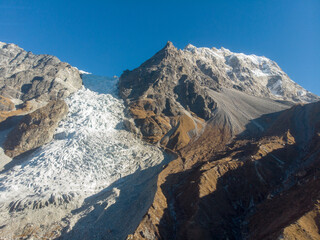 A stunning view of snow-capped mountains under a clear blue sky.