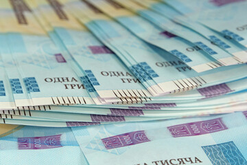 Fototapeta premium Banknotes 1000 Hryvnia. Real Ukrainian paper money of blue yellow color