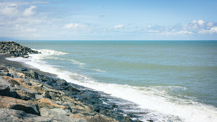 panoramic view of Batumi beach. Sea waves, stone shore with white foam. Georgia