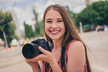 Photo of cheerful funny girl photographer amateur photographing capturing taking pictures photos...