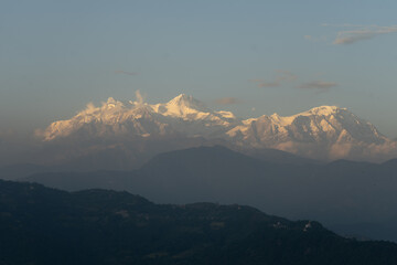 A stunning view of a snow-covered mountain range at dusk.