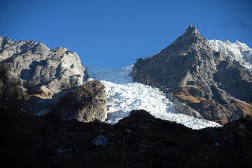 A breathtaking view of snow-capped mountains under a clear blue sky.