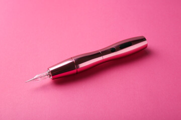Professional permanent makeup machine on pink background