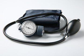 Blood pressure measuring device on white background, closeup