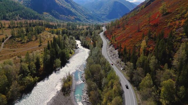 the car is driving along the road in the Altai mountains in autumn