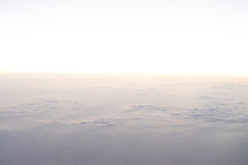 A serene view above the clouds at sunrise.