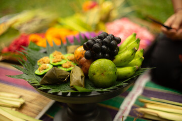 A traditional platter filled with an assortment of exotic fruits and local delicacies.