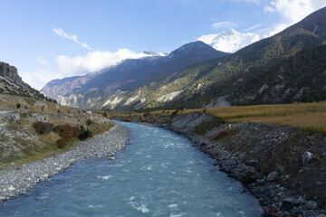 A serene mountain river flowing through a scenic valley