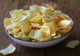 Healthy snack of low-fat lentil chips with herbs and sour cream in bowl