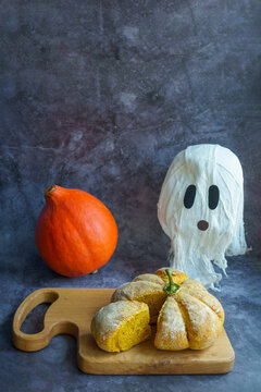 Naklejki Homemade bread in the form of a pumpkin on a gray background. funny creative food for children Halloween party, children brunch or breakfast.