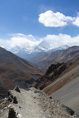 A breathtaking view of a mountainous landscape with rugged terrain under a bright blue sky.