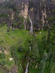 A majestic waterfall cascading down a verdant mountain cliff