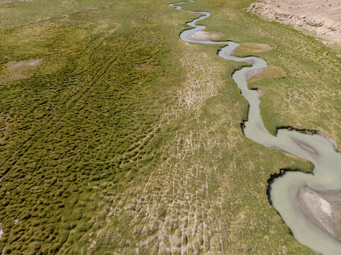 A meandering river flows through a green landscape.