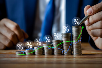 Businessman putting down money, pointing with pen and showing candlestick symbol for investing,...
