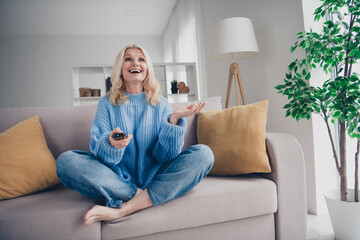 Full size photo of pretty aged sit couch watch tv woman free time modern interior apartment indoors