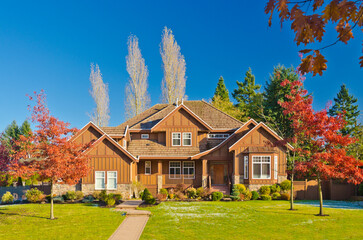 luxury house with garage door, big tree and nice Fall Foliage landscape in Vancouver, Canada