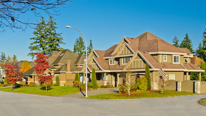 Fototapeta premium luxury house with garage door, big tree and nice Fall Foliage landscape in Vancouver, Canada