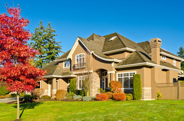 luxury house with garage door, big tree and nice Fall Foliage landscape in Vancouver, Canada