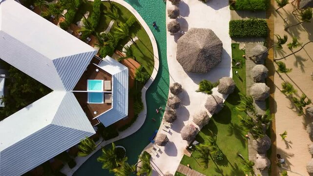 Top aerial view of a luxury resort on the coast of the Dominican Republic. A popular exclusive resort. A beach with golden sand. Paradise tropical nature, exotic holidays, vacations, travel.