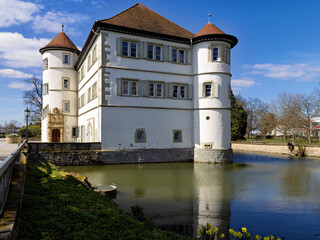 View of the moated castle of Bad Rappenau at the beginning of spring with reflections in the castle moat