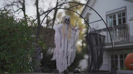 In vibrant European yard, Halloween decor comes alive during day. Colorful pumpkins sit beside playful skeletons and whimsical ghosts, creating festive atmosphere. Decorate yard for Halloween holiday