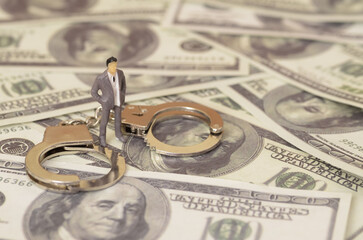 he miniature figure and the handcuffs suggests the possibility of arrest and imprisonment for those...