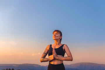 Woman Practicing Breathing Yoga on Nature at Sunset