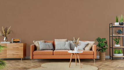 Modern cozy living room interior with a brown sofa, decorative plants, and wooden furniture,...