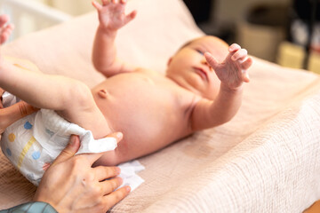 Newborn baby. A mother changes the diapers of a newborn.