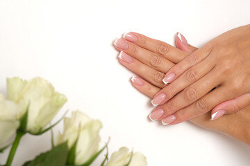 Beautiful feminine hands with French manicure.