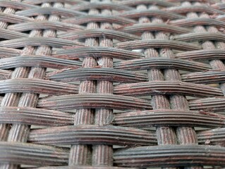 Close-up of wicker basket weave, rattan woven mesh texture background 