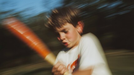 Young boy swinging a bat in motion during a game