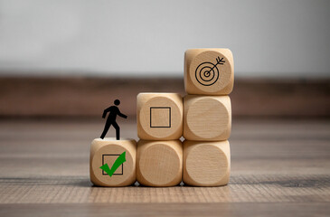 Cubes, dice or blocks with ladder and steps to success on wooden background