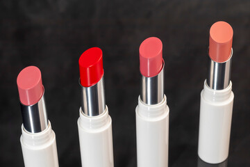 colored lipstick in light tubes. Cosmetic accessories.