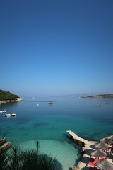 Idyllic Dining: View of Bright Blue Water from a Restaurant in Ksamil