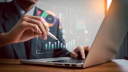 Businessman analyzing financial data on laptop screen  to analyze Financial Data with KPI and...